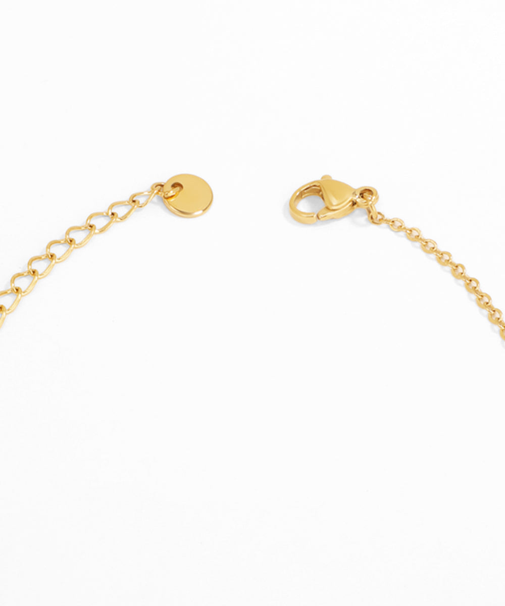 Gold bracelet with clasp on a white background
