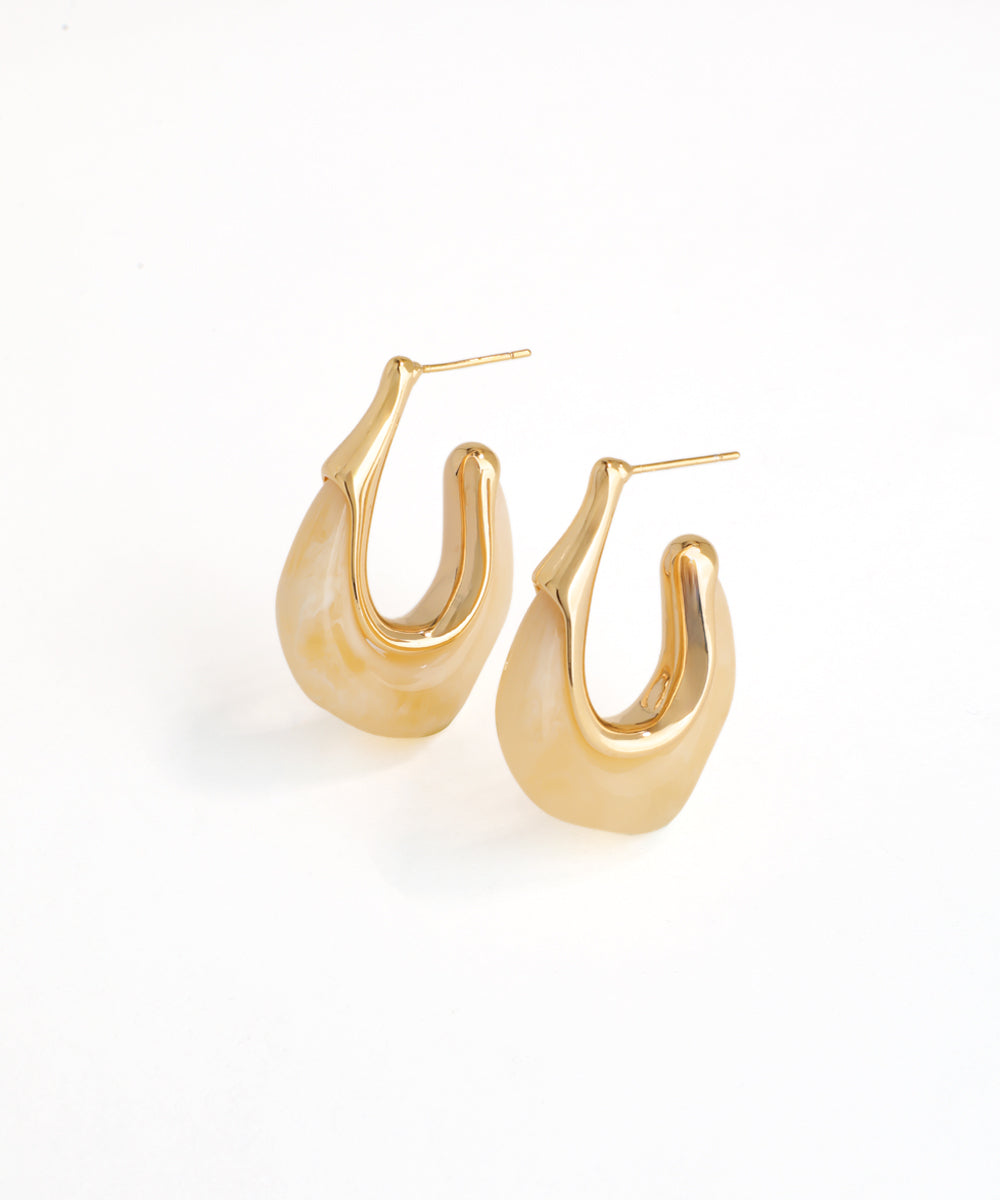 Gold hoop earrings on a white background