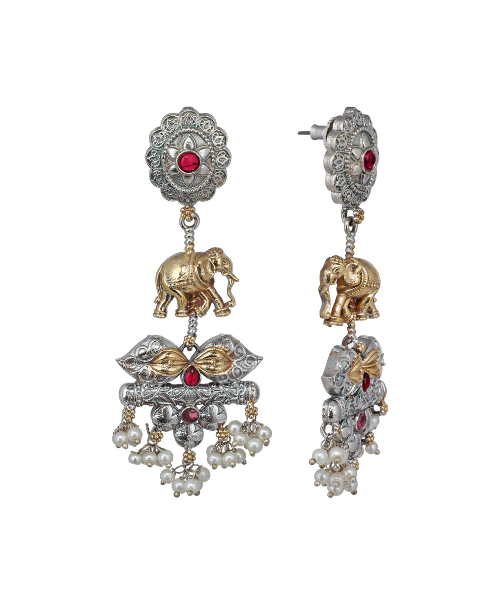 Ornate earrings with elephants and gemstones on a white background