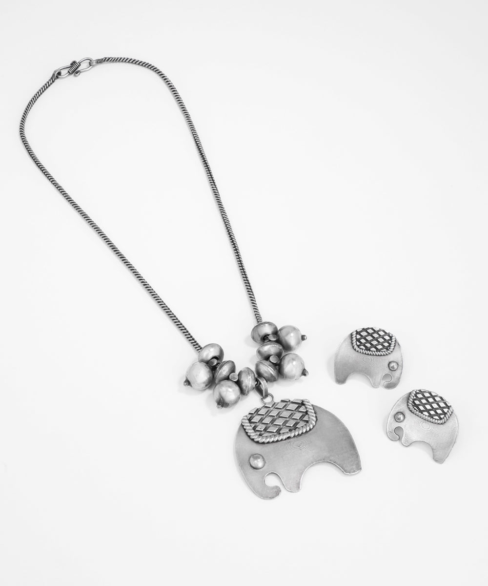 Silver elephant necklace and earrings on a white background
