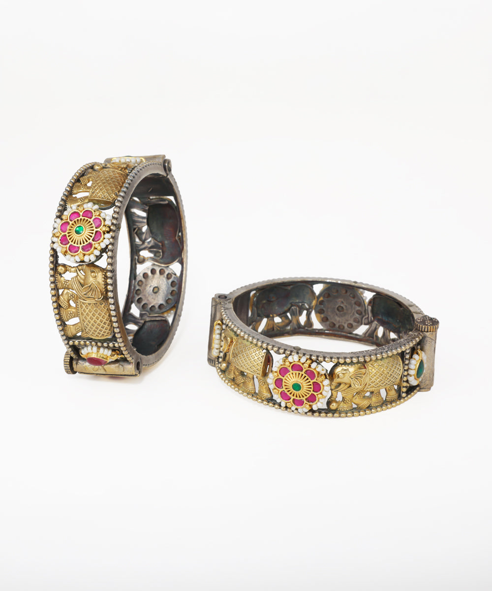 Decorative bangles with intricate designs on a white background