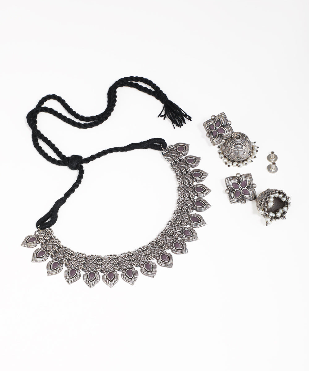 Silver necklace with matching earrings on a white background