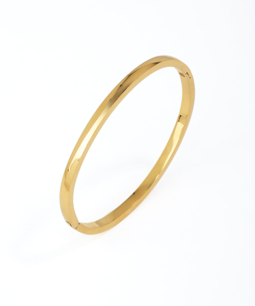 Gold bangle on a white background