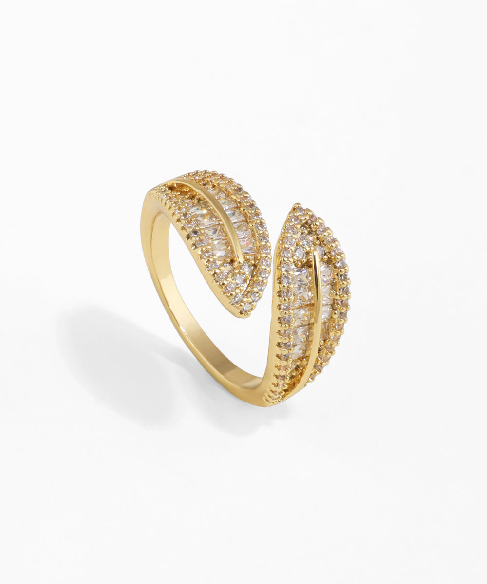 Gold-tone ring with two intertwined bands set with clear round and baguette cut CZ stones in an open design