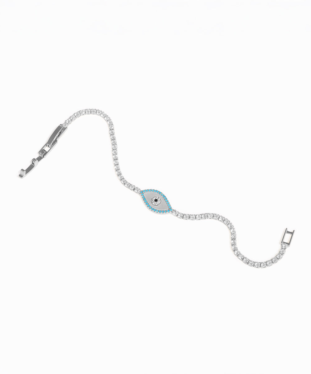 Silver bracelet with a blue evil eye charm on a white background