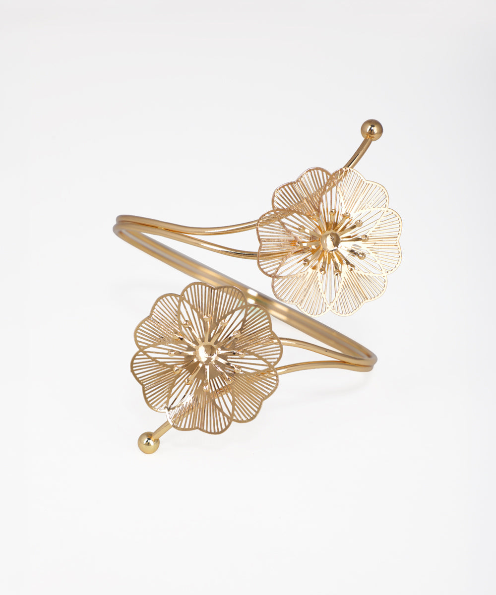 Gold floral bracelet on a light gray background