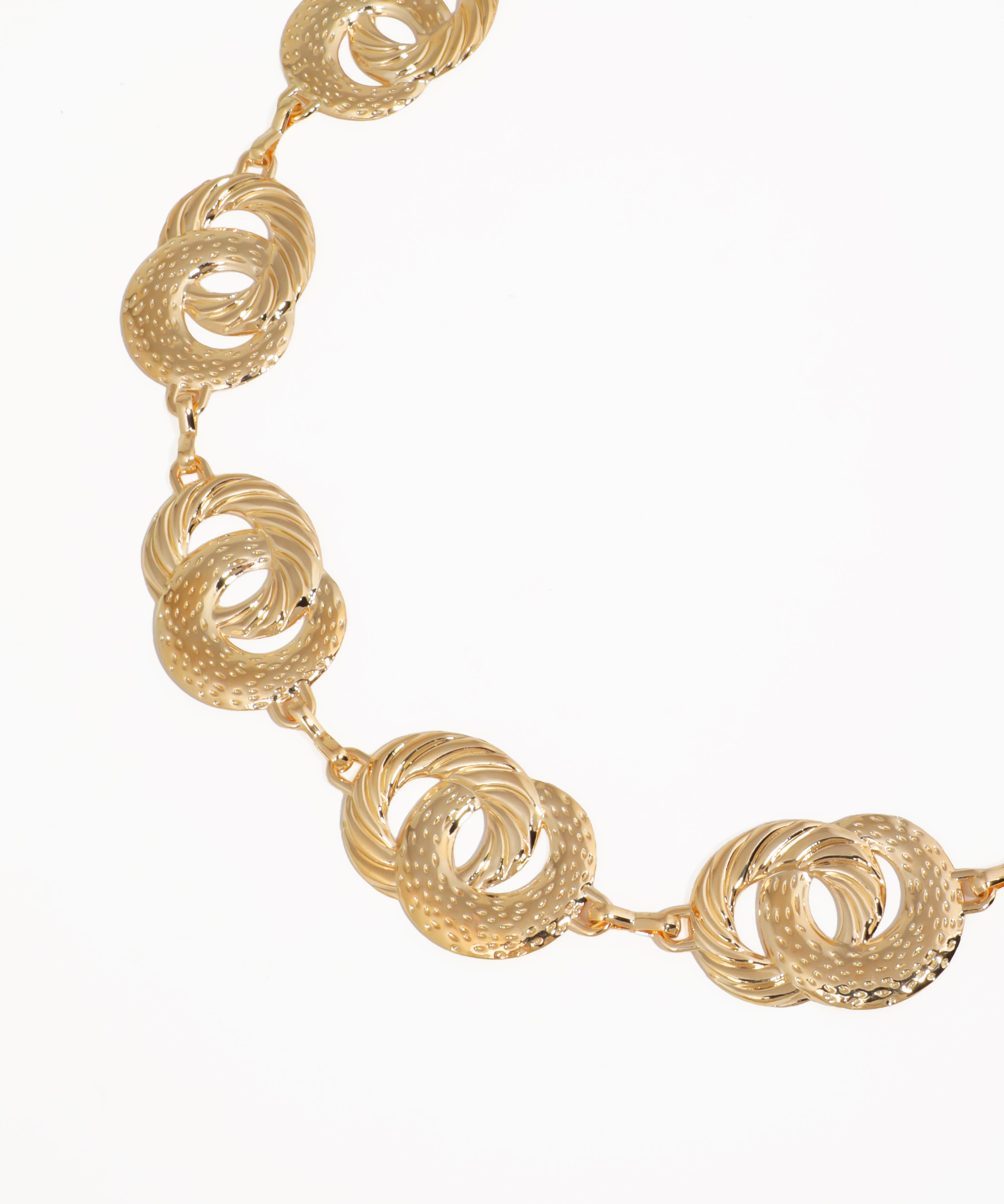 Gold necklace with interlocking circular design on a white background