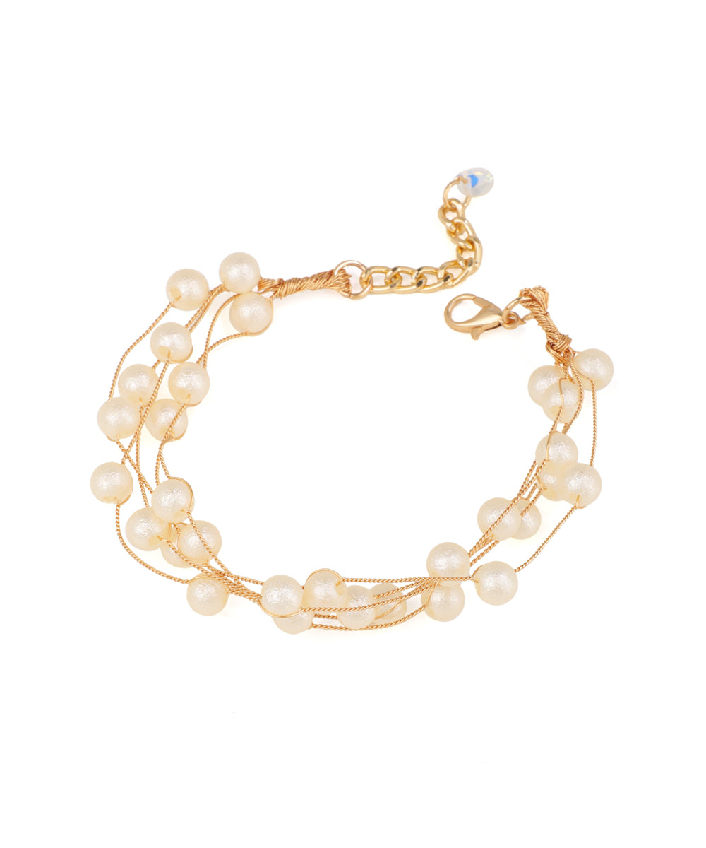 Gold-tone multi-strand bracelet with delicate wire strands and numerous small faux pearls, featuring a lobster clasp.
