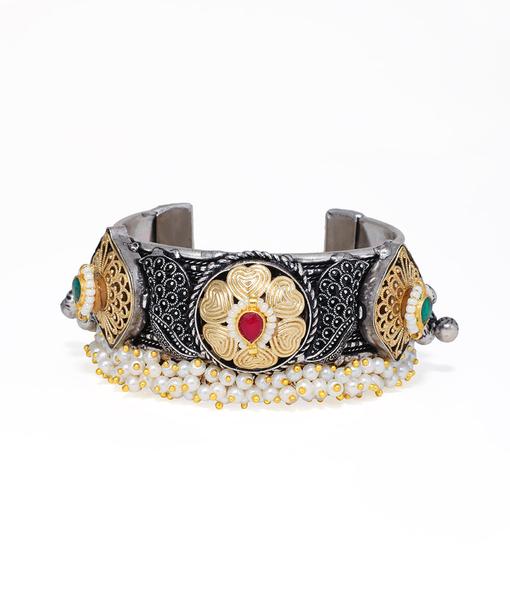 Oxidized and gold-tone cuff bracelet with floral motifs, red and green glass crystals, and faux pearl fringe.