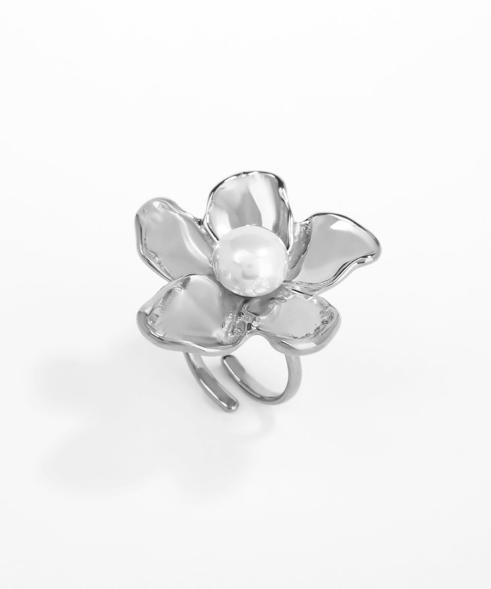 Silver flower-shaped ring on a white background