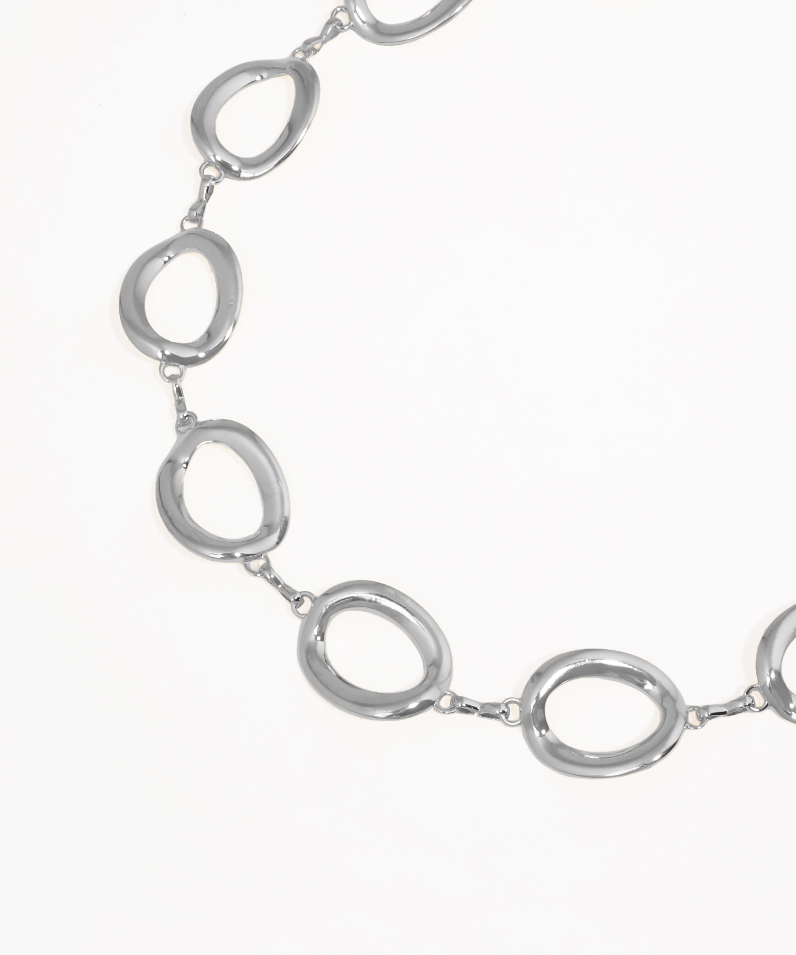Silver necklace with oval links on a white background
