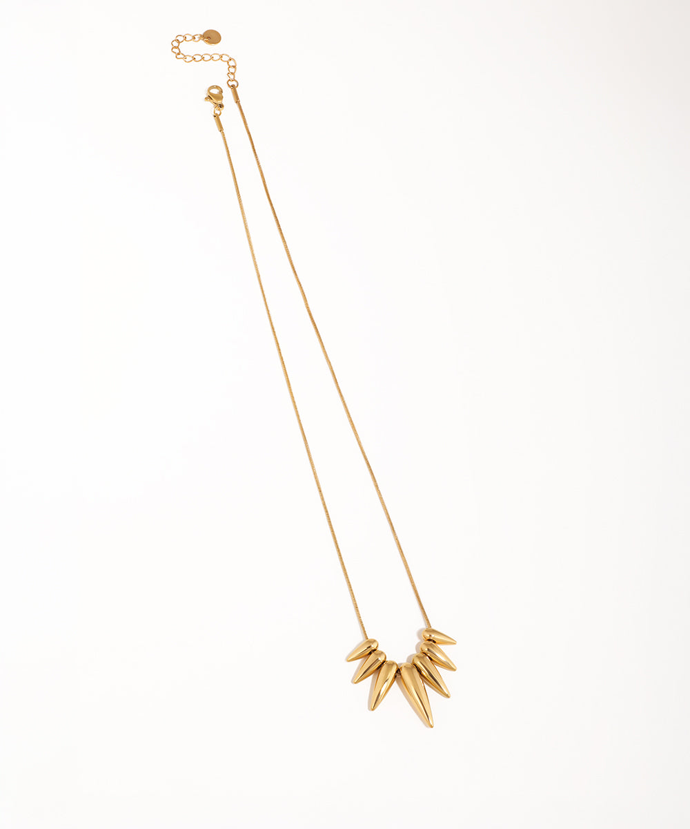Gold-tone necklace with a cluster of polished geometric pointed drops on a thin chain