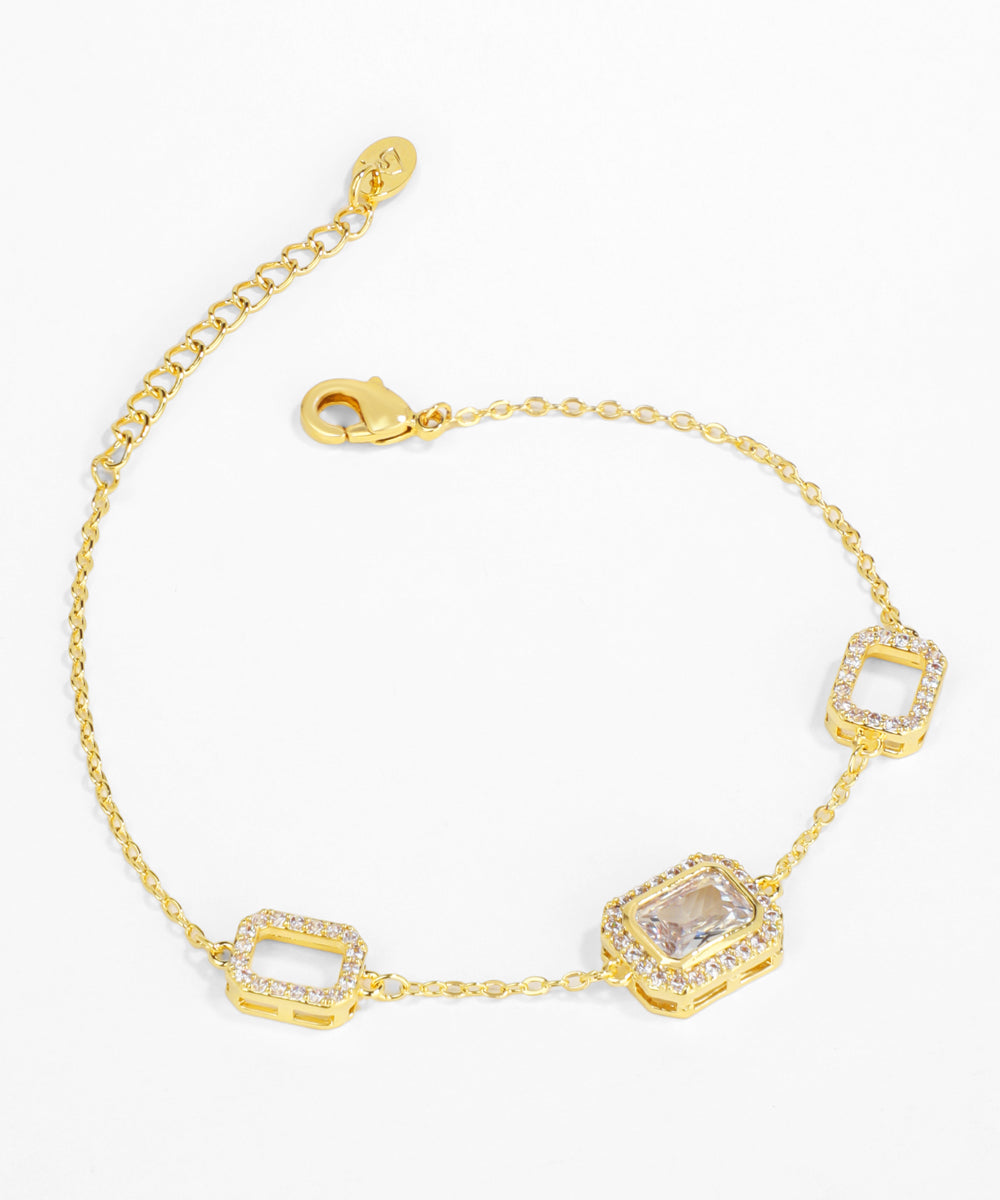 Gold bracelet with square-shaped gemstones on a white background
