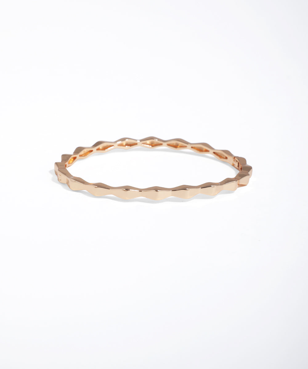Rose gold ring with a textured band on a white background