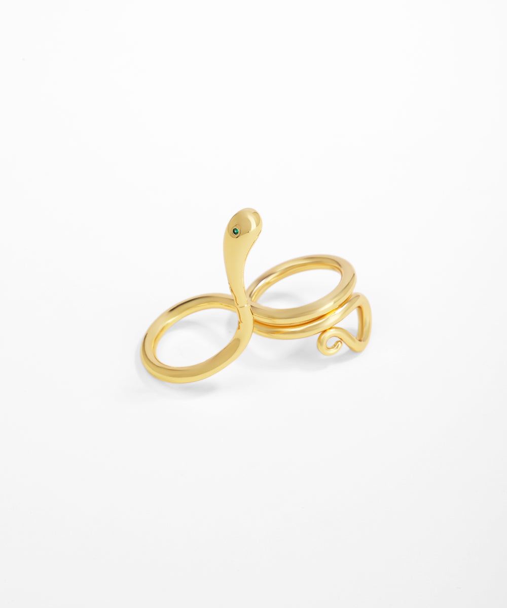 Gold snake-shaped ring on a white background