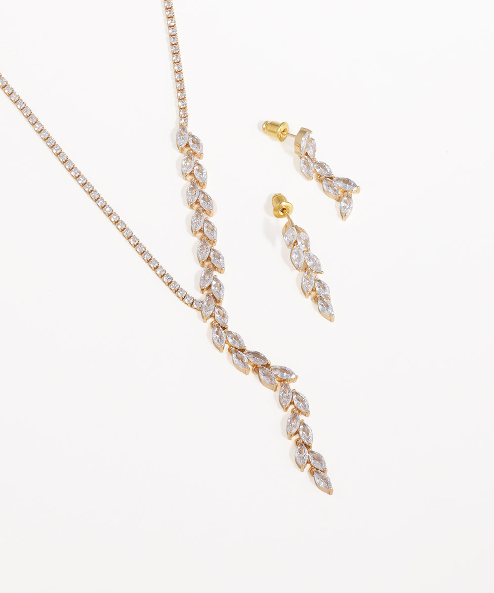 Gold necklace and earrings set on a white background