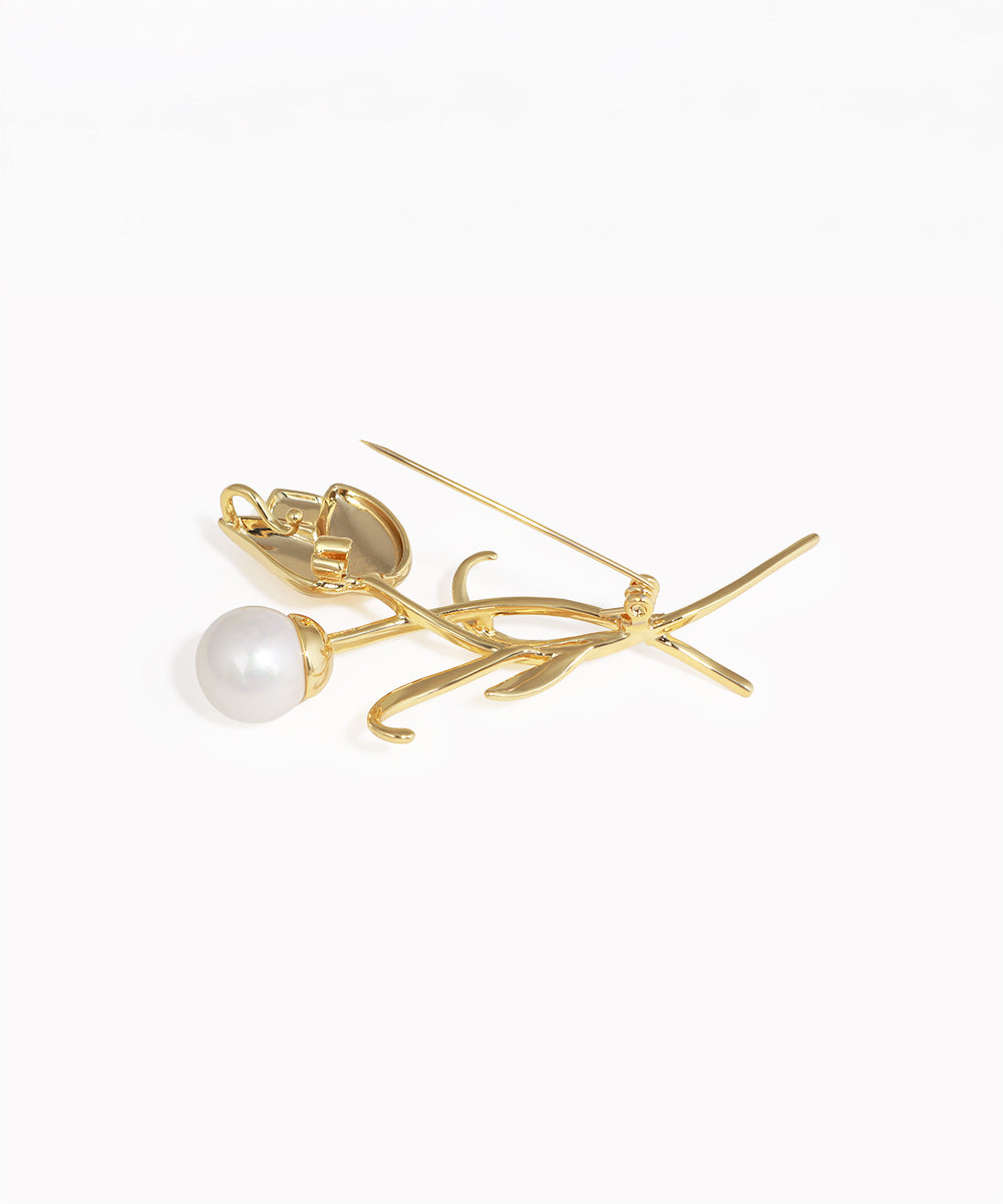 Gold earring with a pearl on a white background