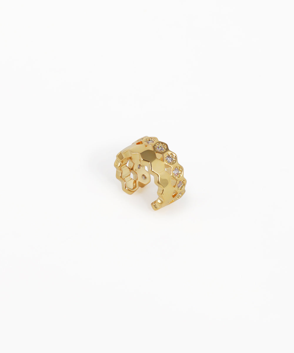 Gold-tone ear cuff with hexagonal grid pattern and clear stones