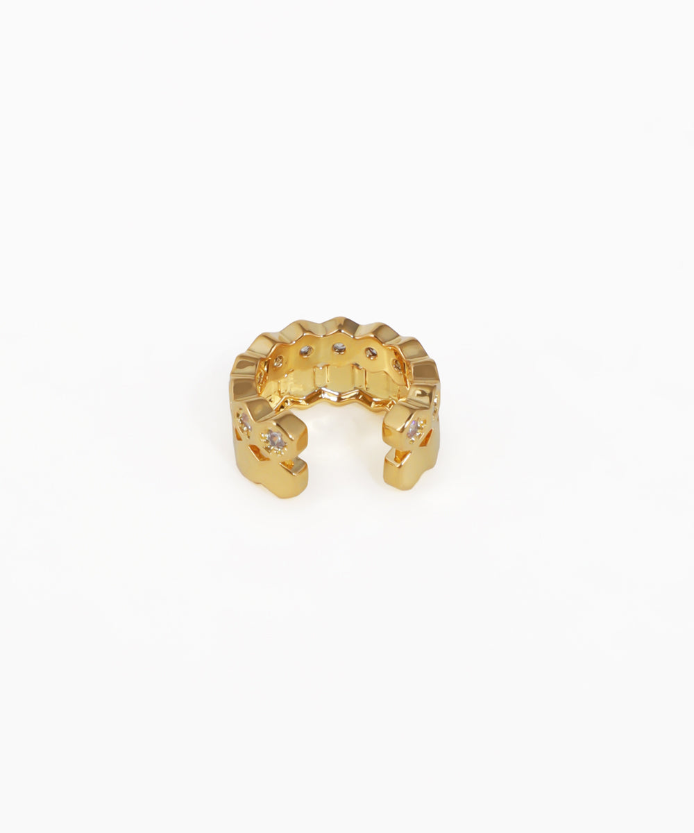 Gold ring with small diamonds on a white background