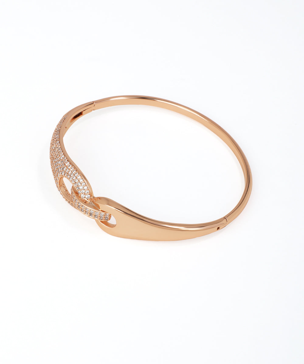 Rose gold bracelet with intricate design on a white background