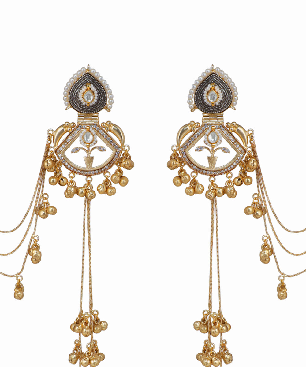 Pair of ornate gold earrings with intricate designs on a white background