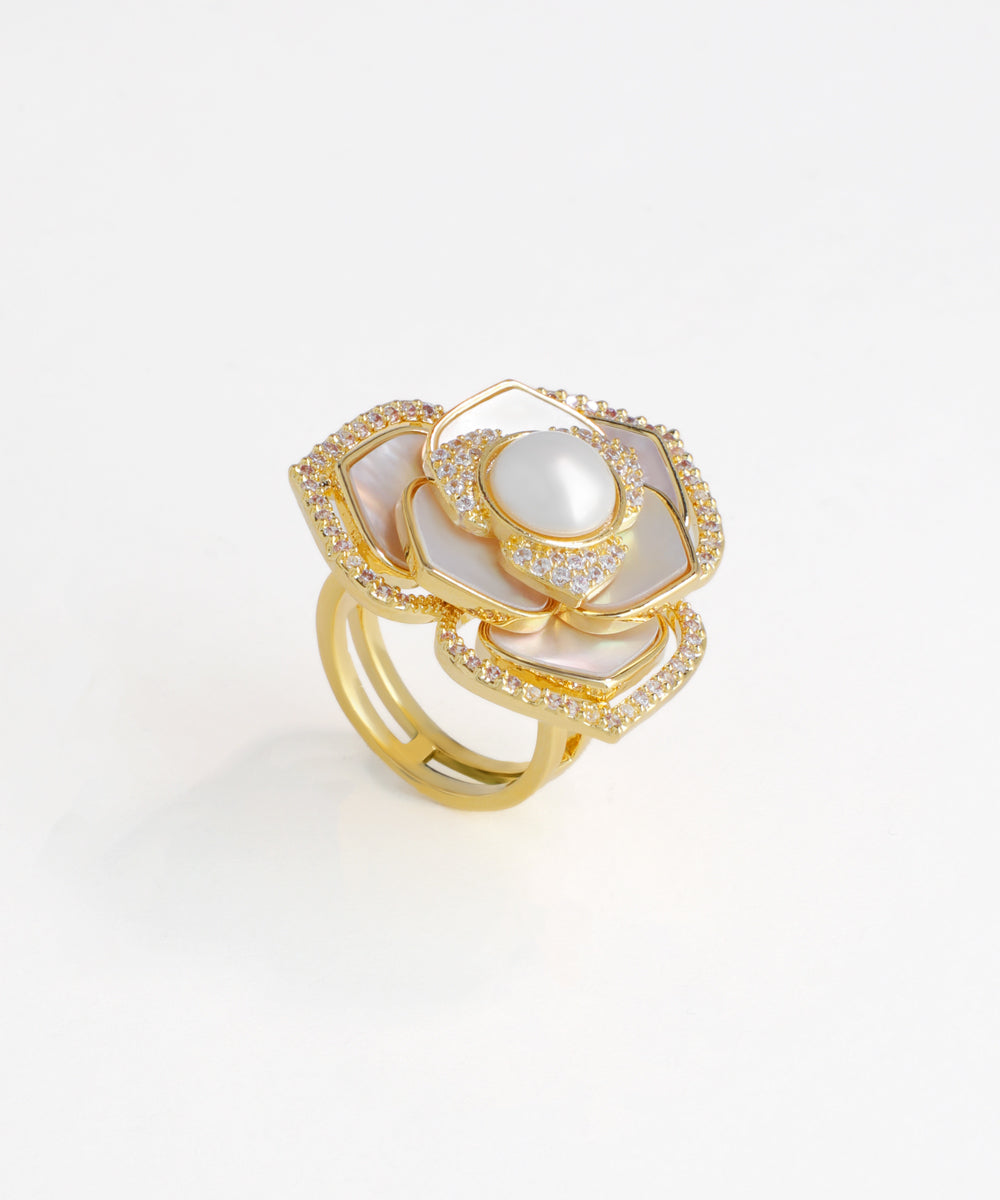 Gold ring with a pearl on a light gray background