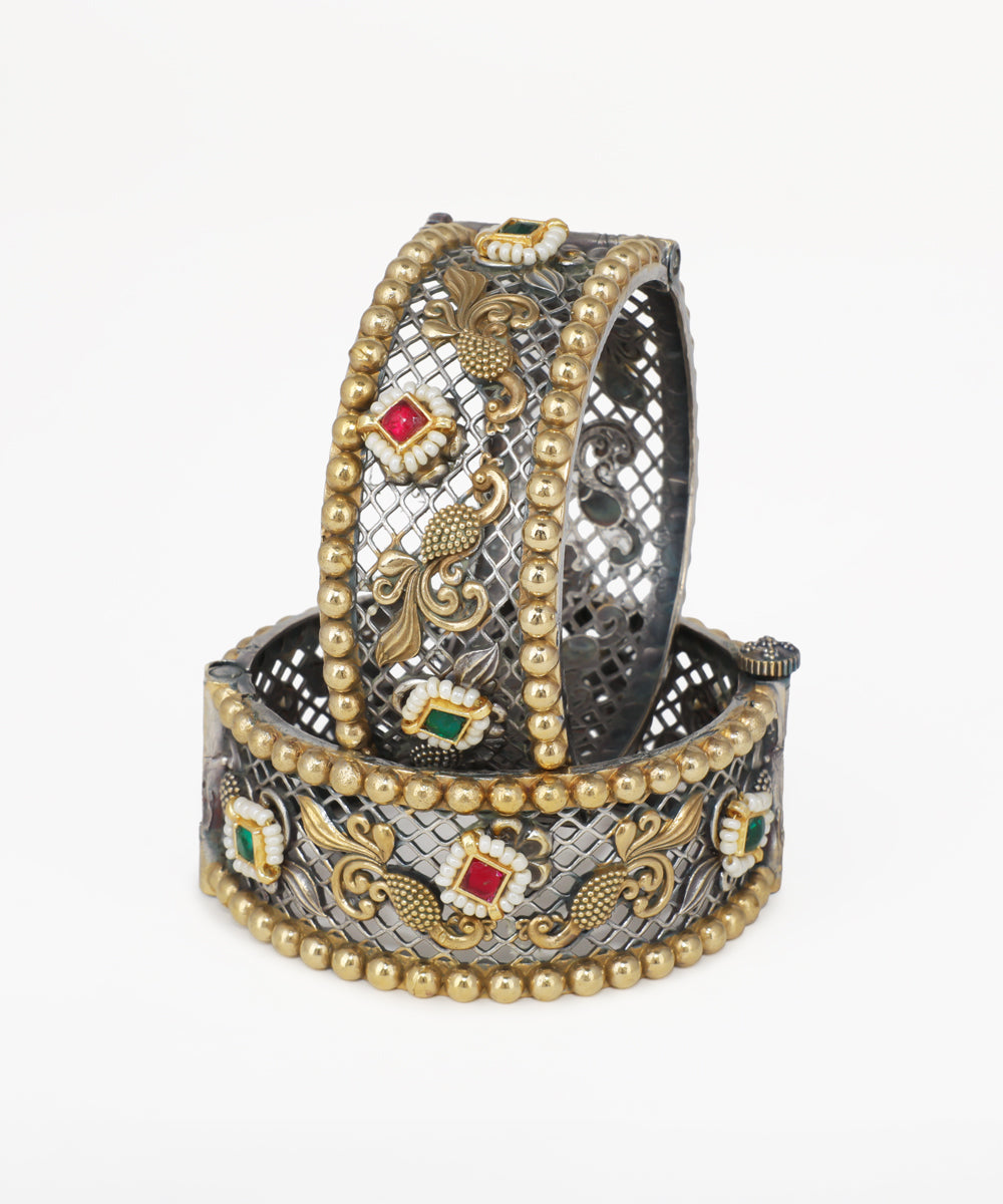 Decorative bracelet with gold and silver design on a white background