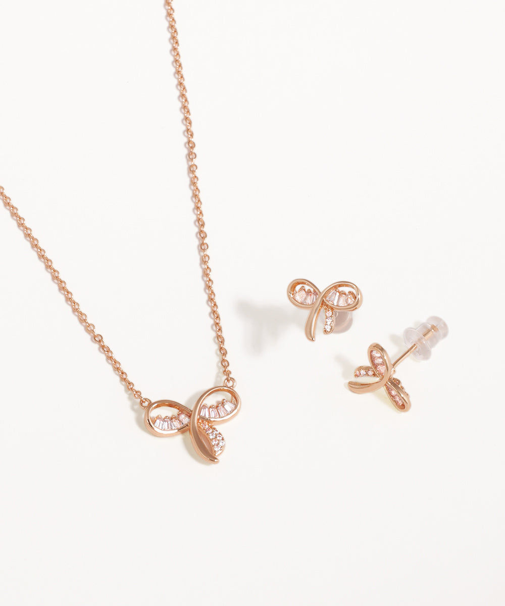 Rose gold necklace and earrings on a white background