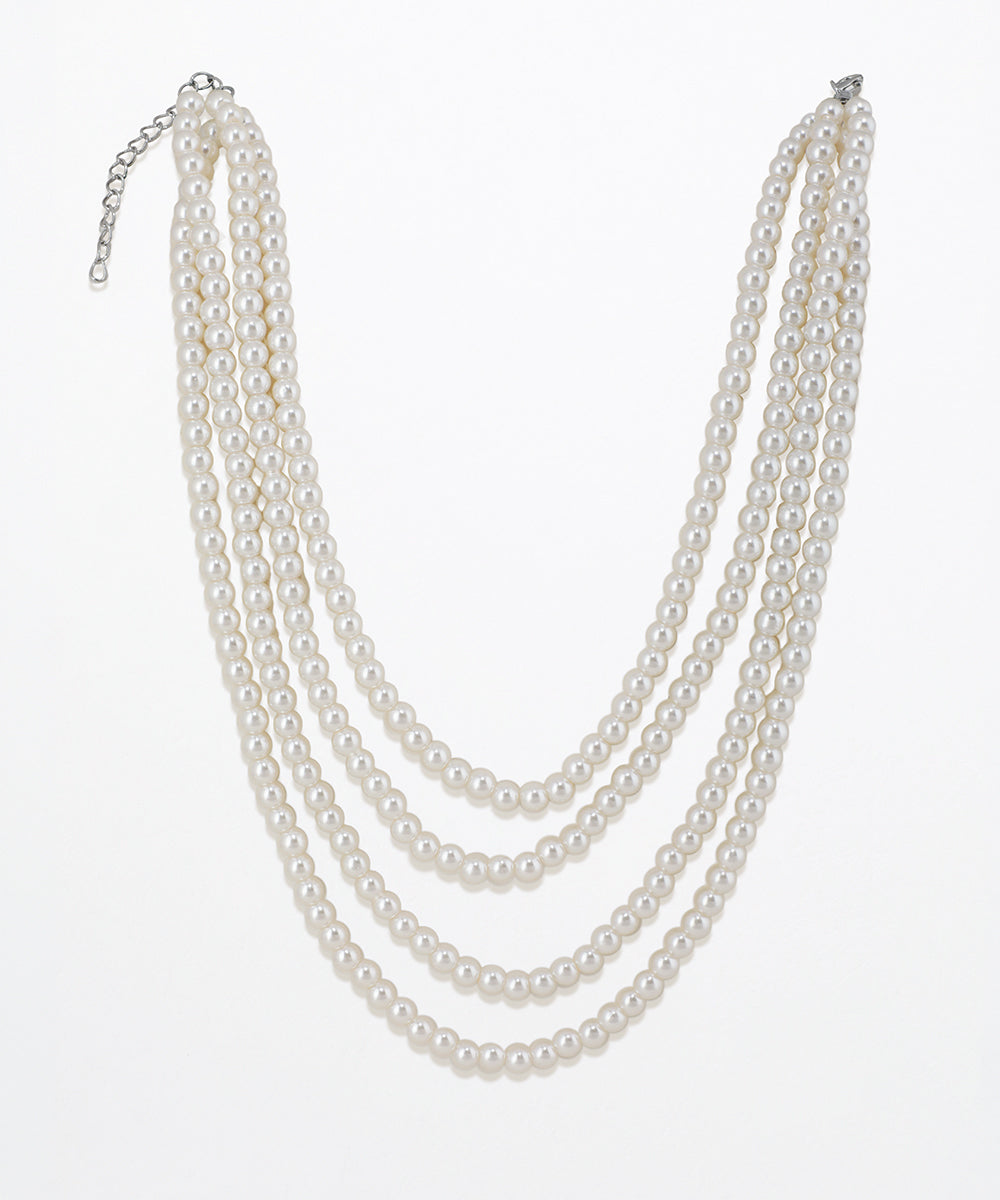 Silver-tone triple strand necklace with white faux pearls and an extender chain