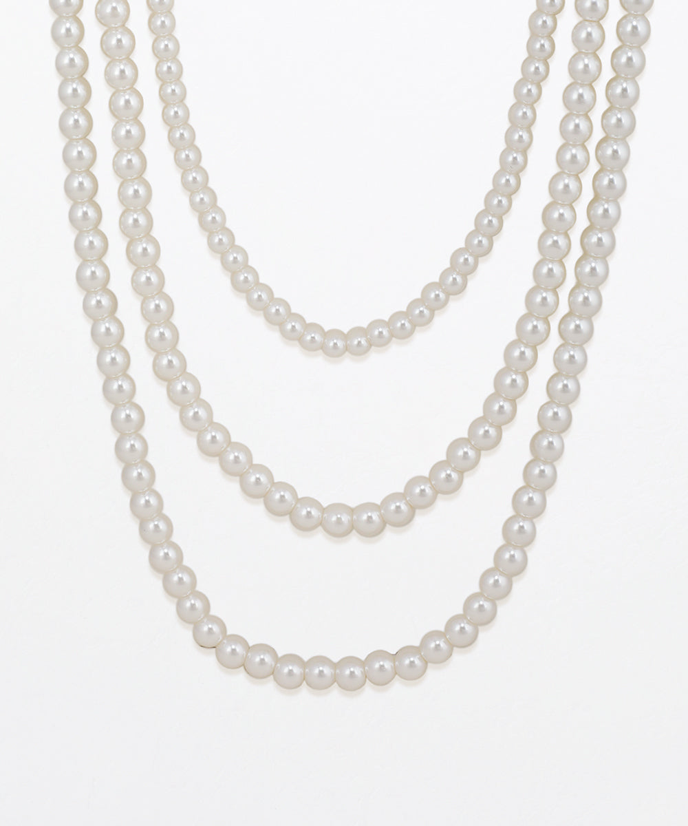 Two pearl necklaces on a white background