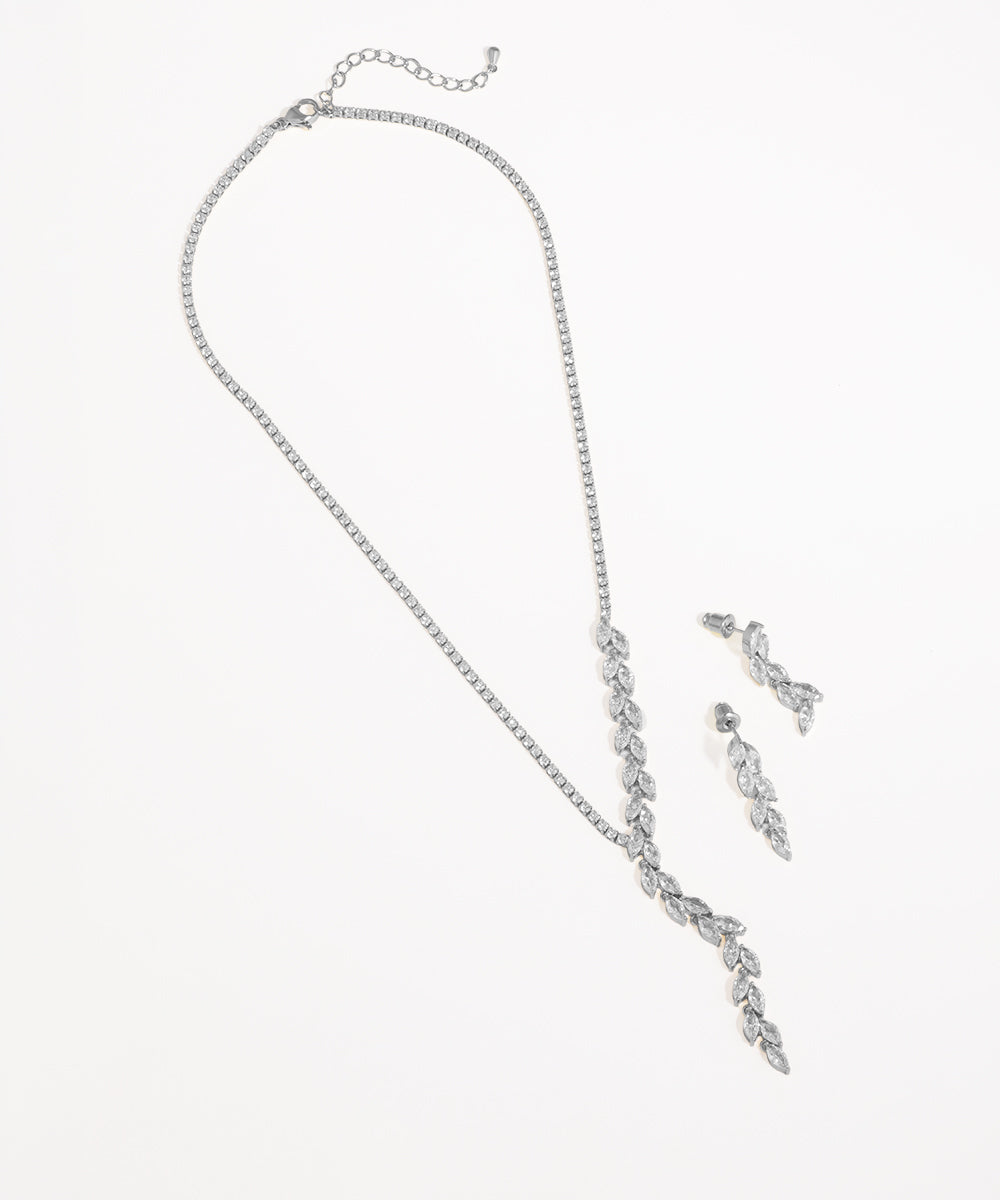 Silver necklace and earrings set on a white background