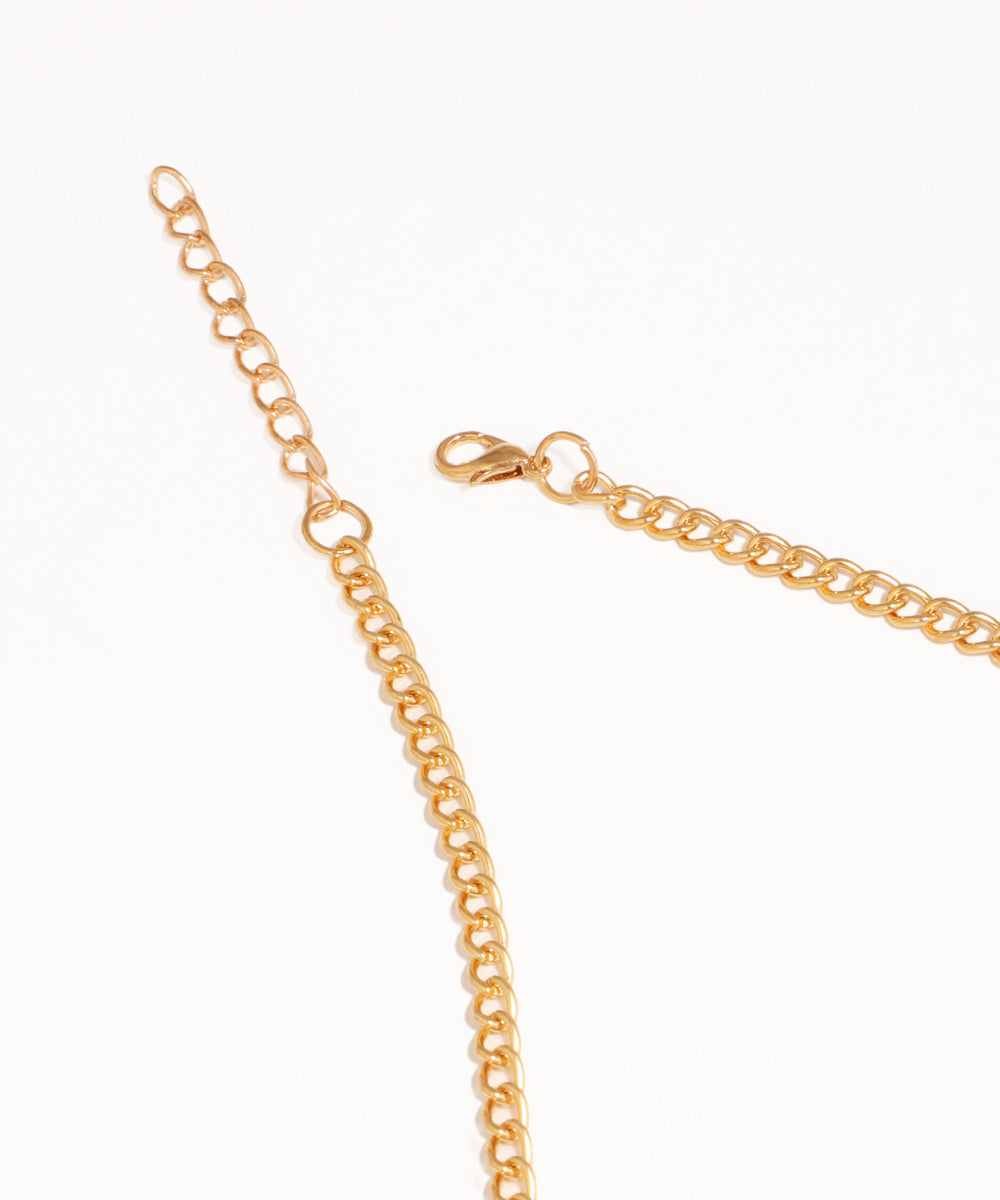 Gold chain necklace on a white background