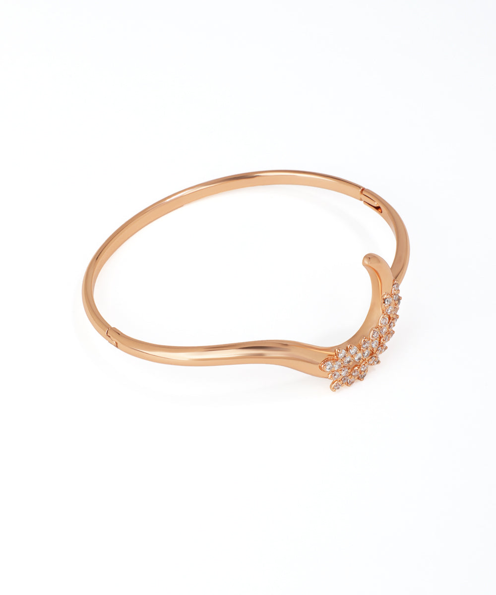 Rose gold bracelet with small diamonds on a white background