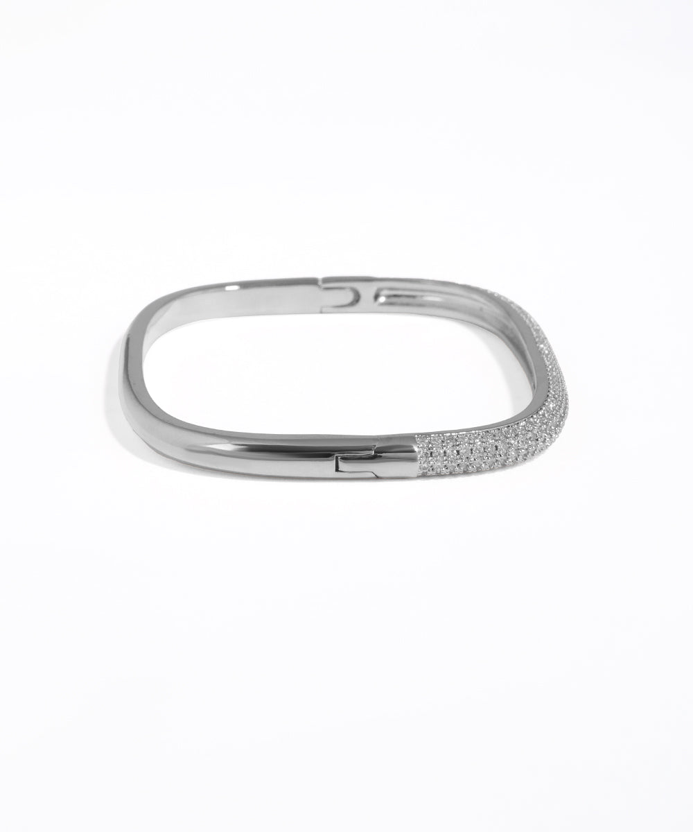 Silver bracelet with small stones on a white background