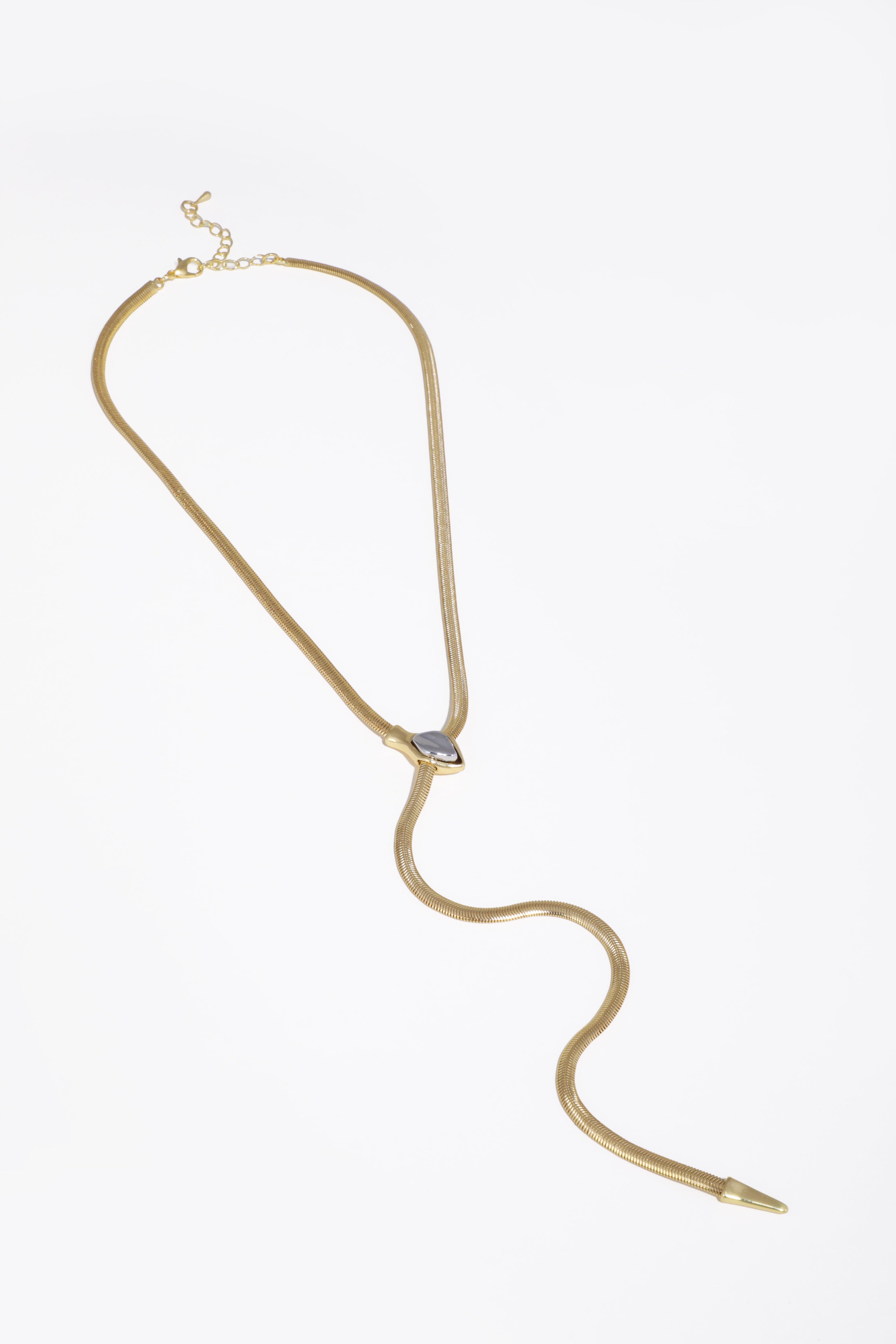 Gold necklace with a small pendant on a white background
