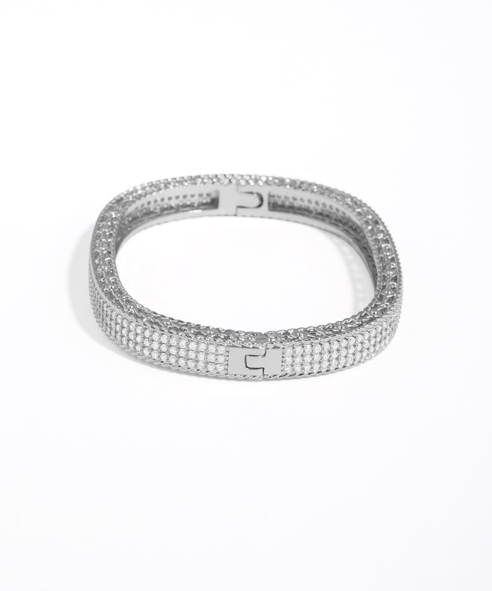 Silver bracelet with clear stones on a white background