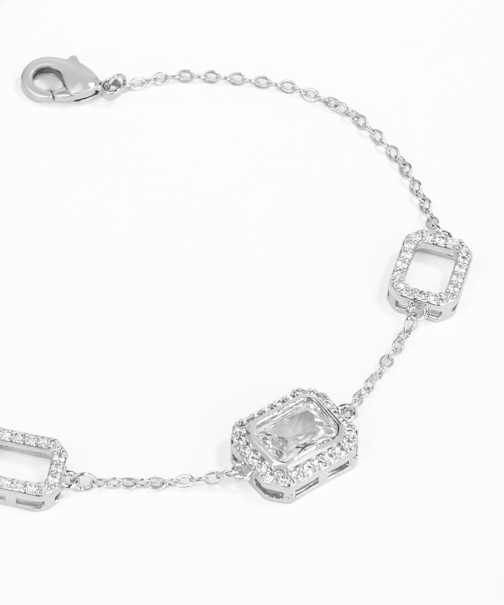 Silver bracelet with rectangular links on a white background