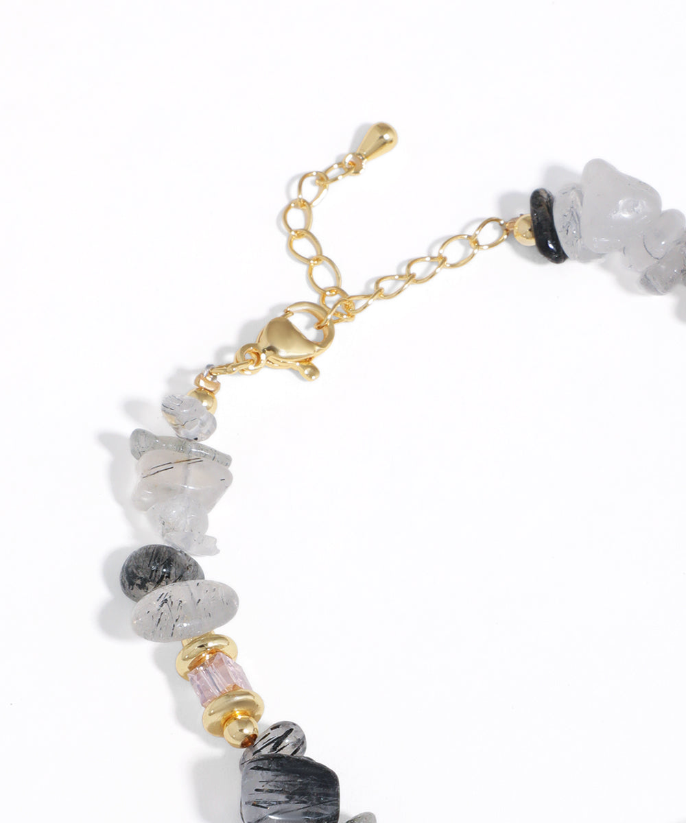 Necklace with multicolored beads and gold chain on a white background