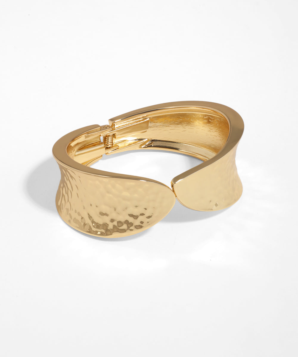 Gold bracelet on a white background