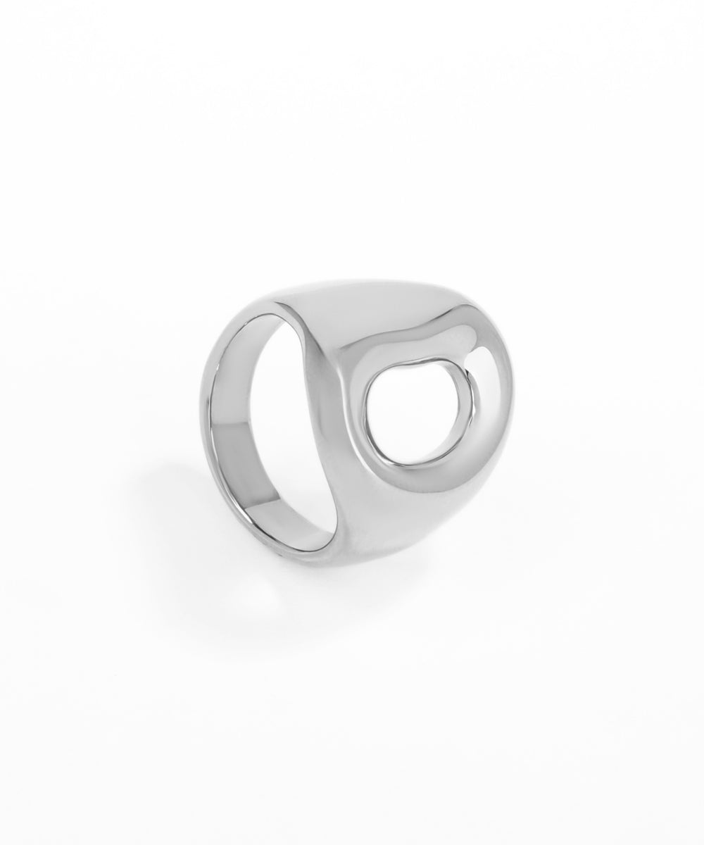 Silver ring with a circular design on a white background