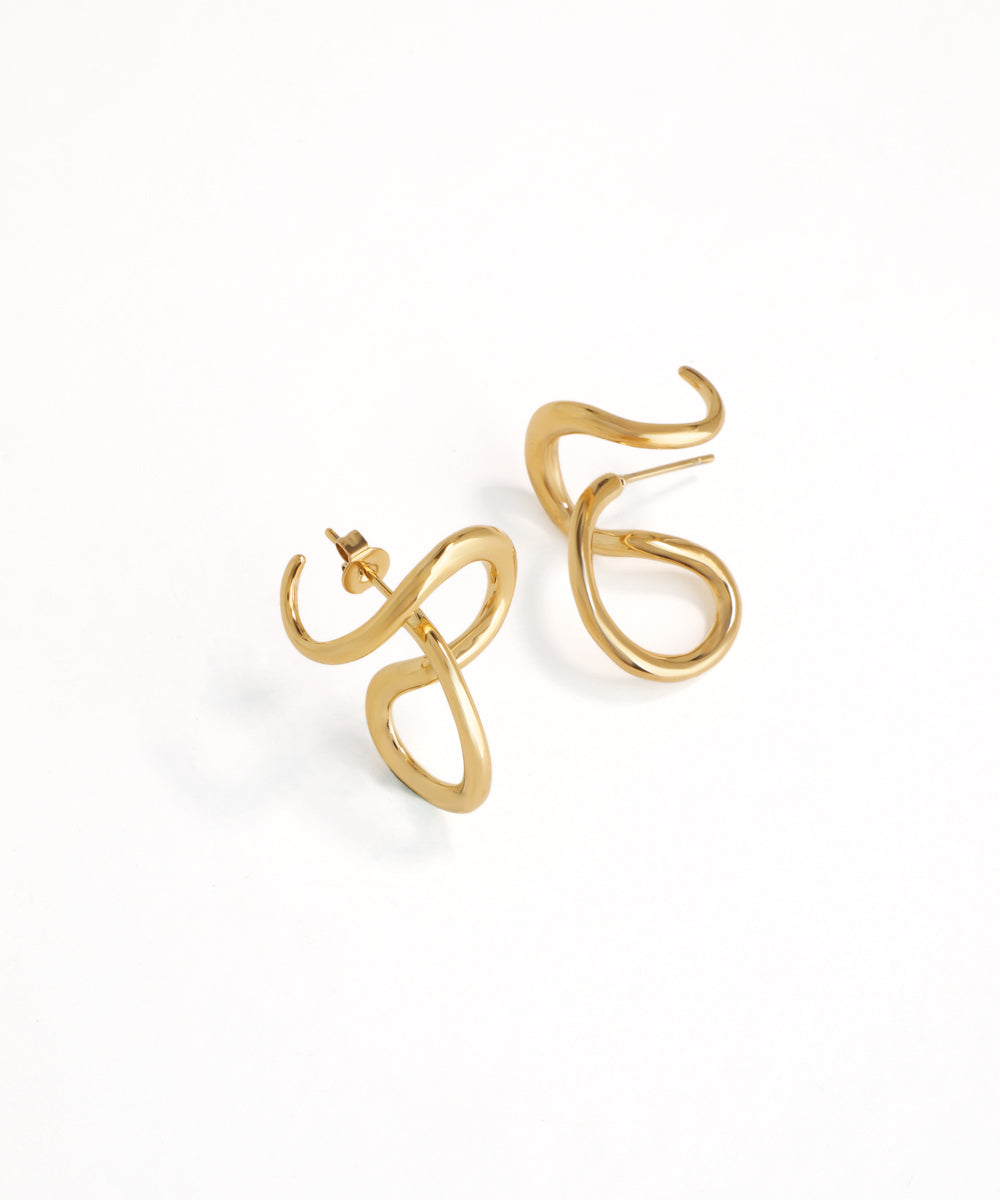 Gold earrings on a white background