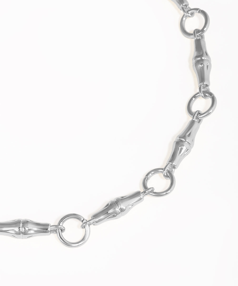Close-up of a silver chain bracelet on a white background