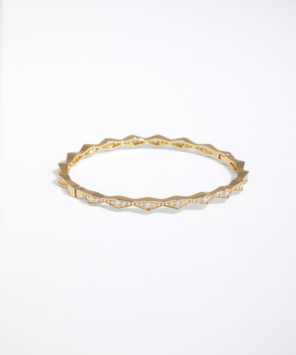 Gold ring with small diamonds on a white background