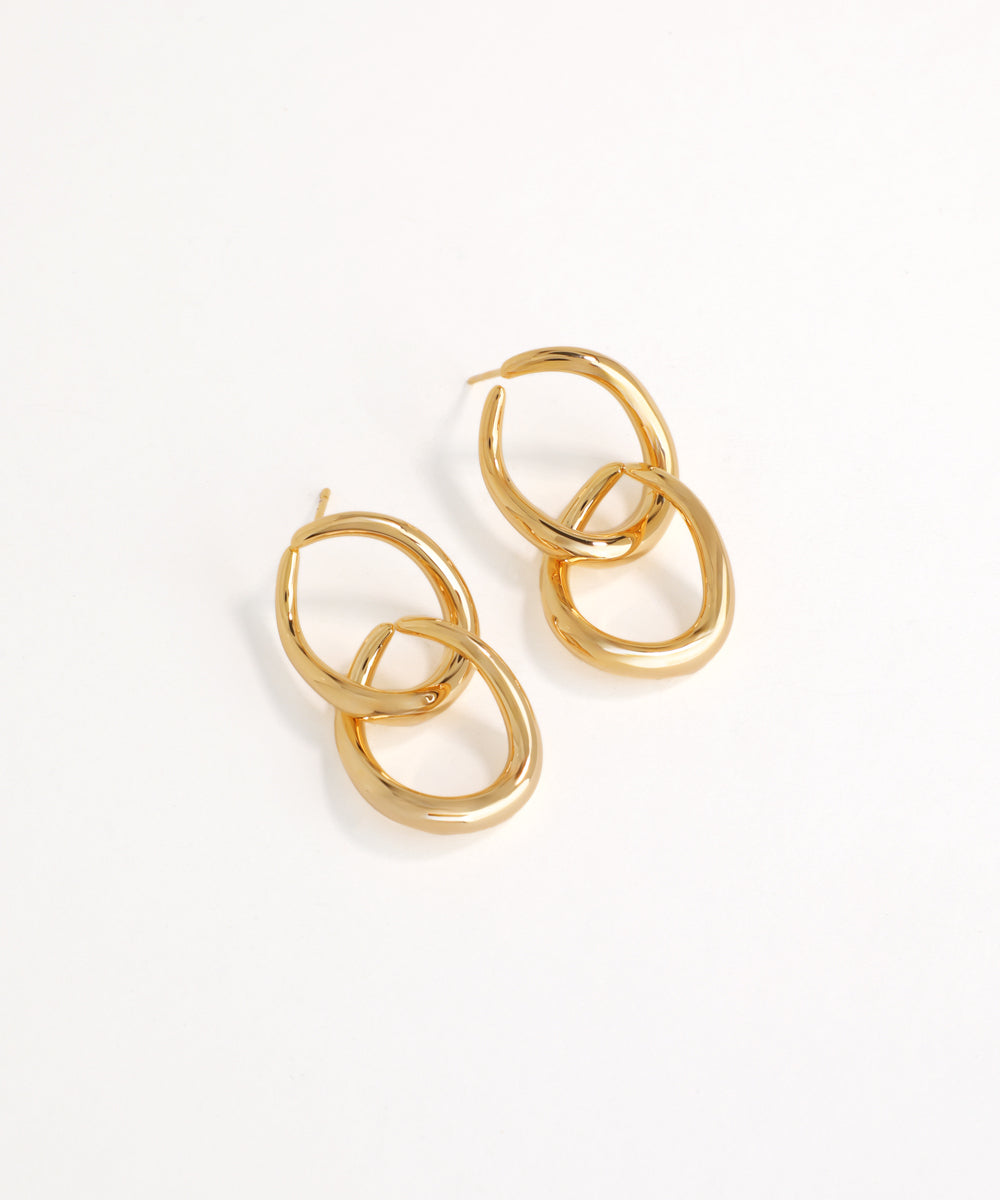 Gold interlocked linked hoop earrings on a white background