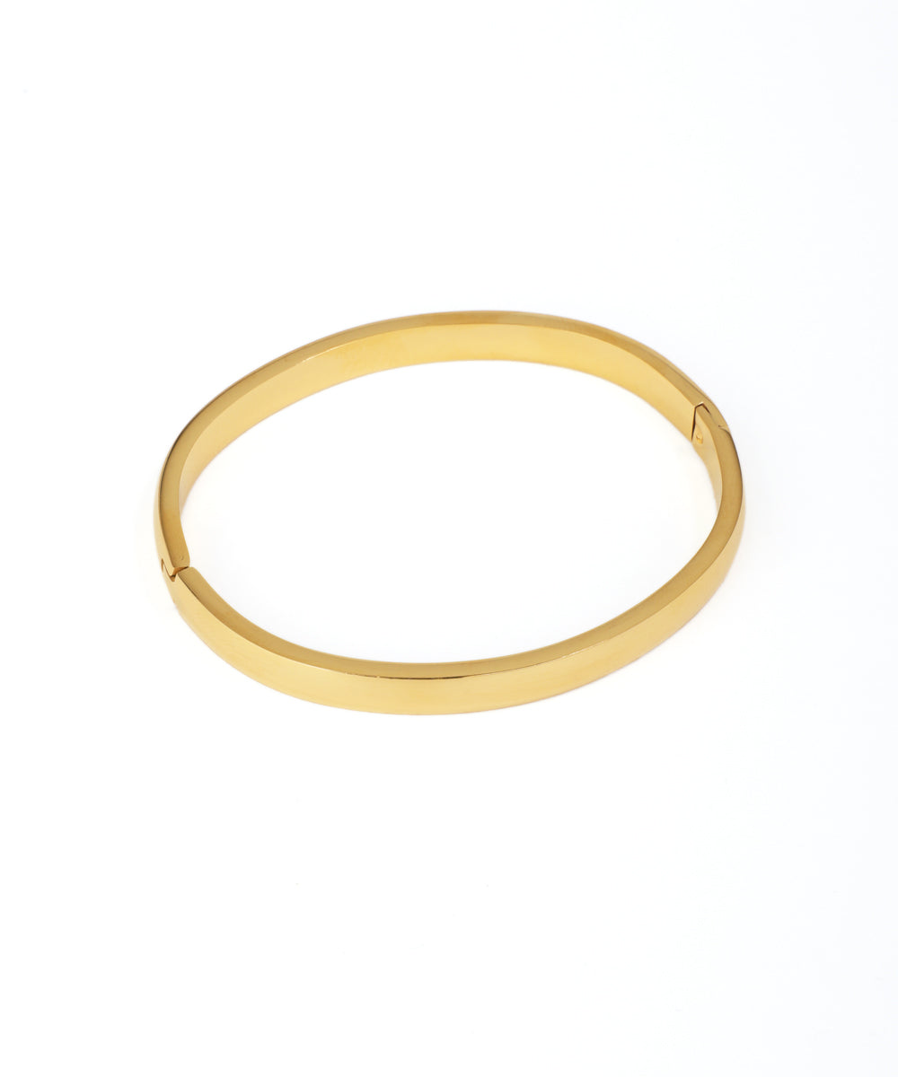 Gold bangle on a white background