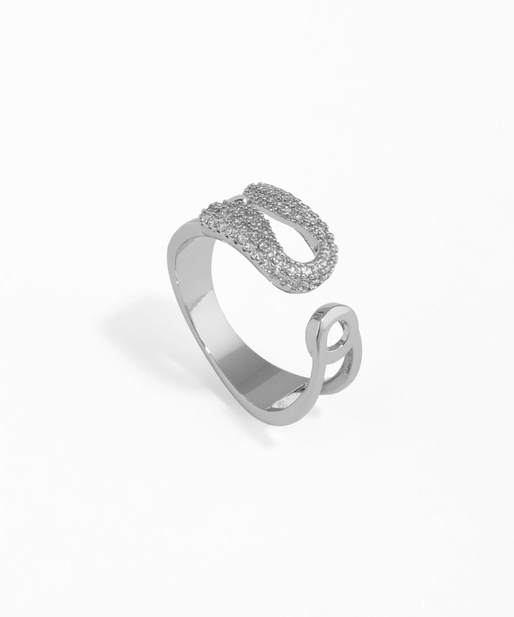 Silver open ring with intricate design on a white background