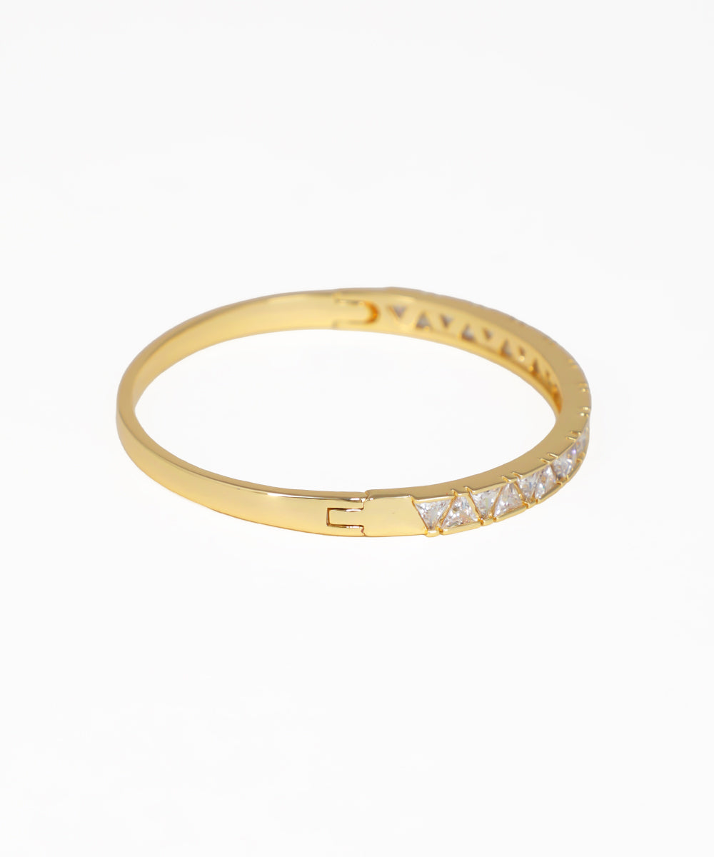 Gold ring with small diamonds on a white background