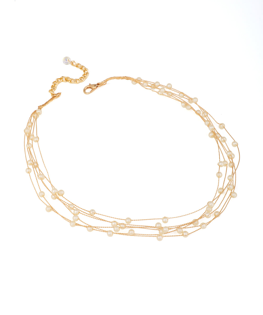 Gold-tone necklace with multiple delicate strands featuring small cream faux pearls and an extender clasp.