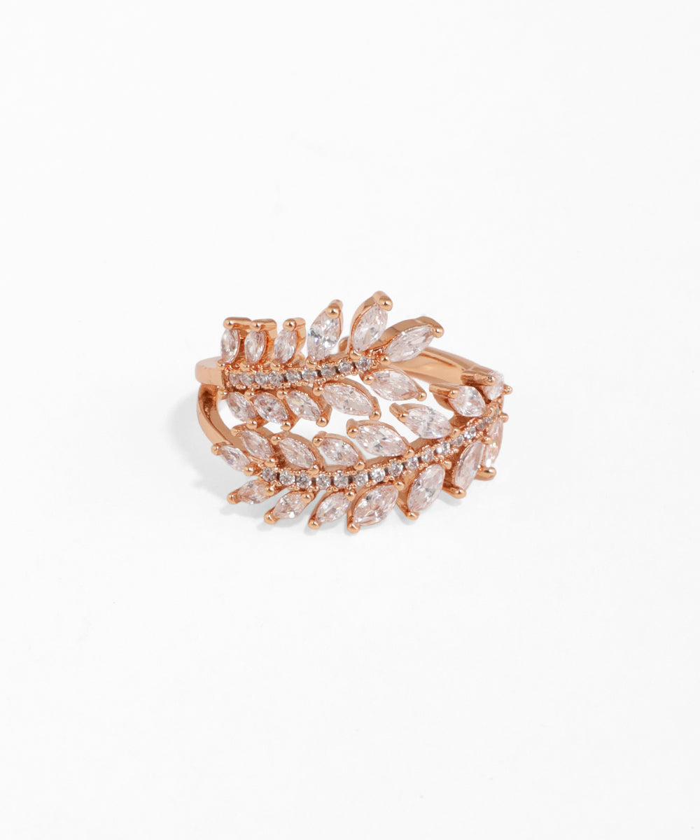 Rose gold ring with diamond leaves on a white background