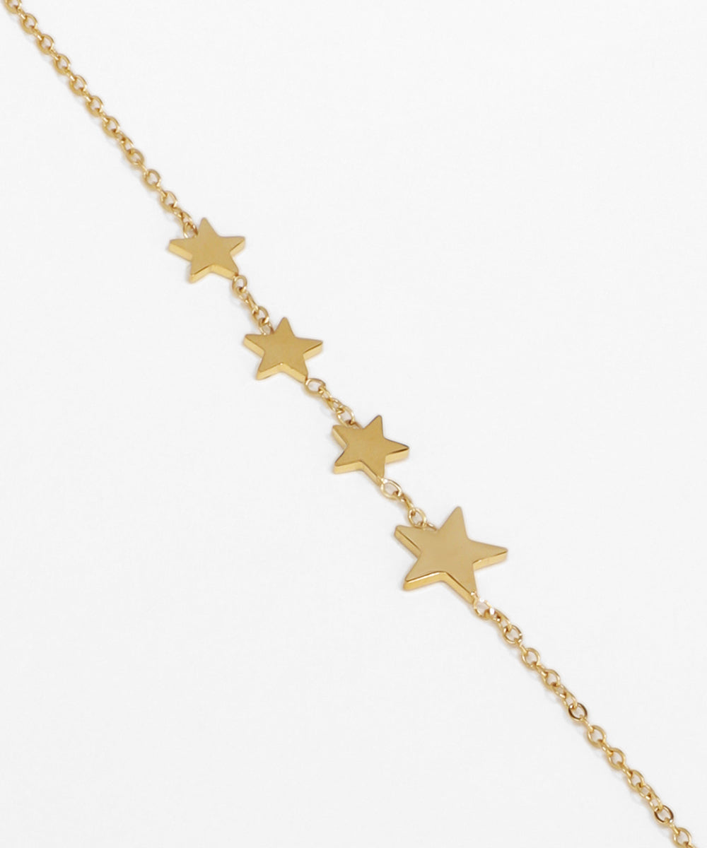 Gold star bracelet on a white background